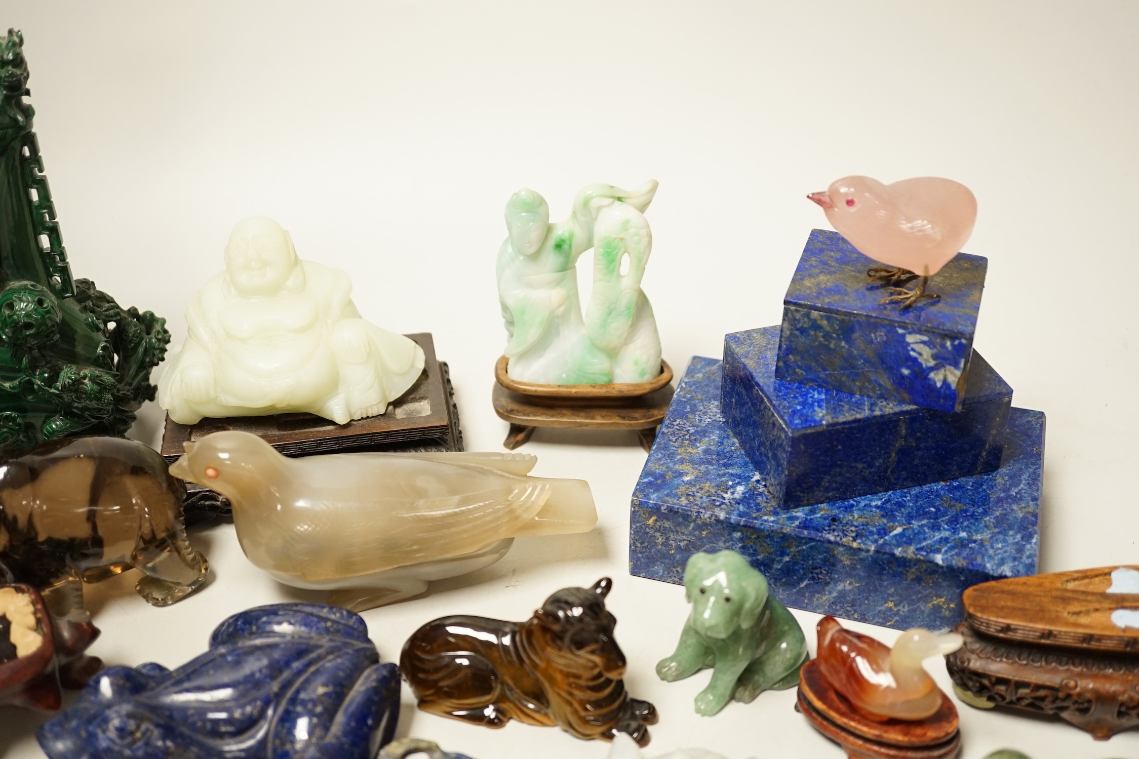 A collection of assorted Chinese hardstone carvings, boxes etc, including a Chinese jadeite carving of a lady, 7.8cm high, wood stand